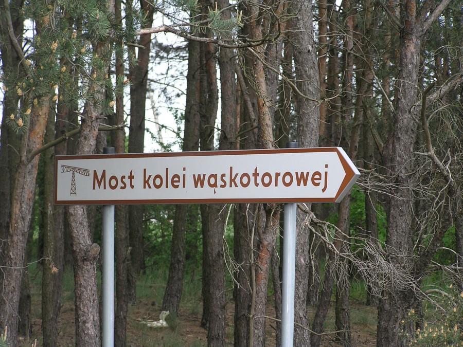 Znak zachęcający do odwiedzin mostu kolejki wąskotorowej w Koronowie