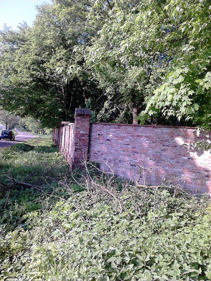 Mur przy drodze w Zaborówku. A za murem budynek. Nigdzie podpisu