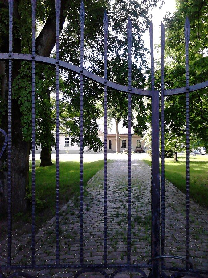 Pałacyk widziany zza ogrodzenia