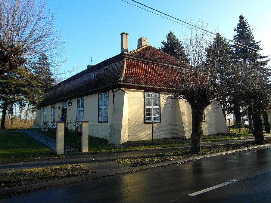 Nieopodal kościoła znajduje się barokowa plebania z 1728r., z mansardowym dachem z lukarnami, krytym dachówką holenderką. W sieni znajduje się tablica erekcyjna z czarnego marmuru. Zachowały się drzwi wejściowe z barokowymi okuciami oraz duże o