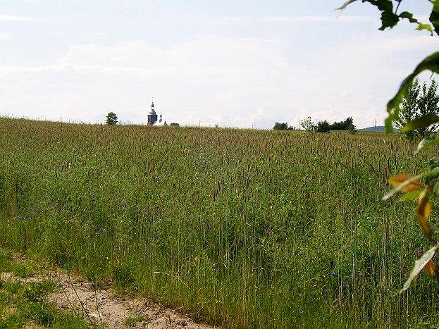 Kościół z sąsiedniej dolinki wynurza się zza garbu swymi strzelistymi wieżami