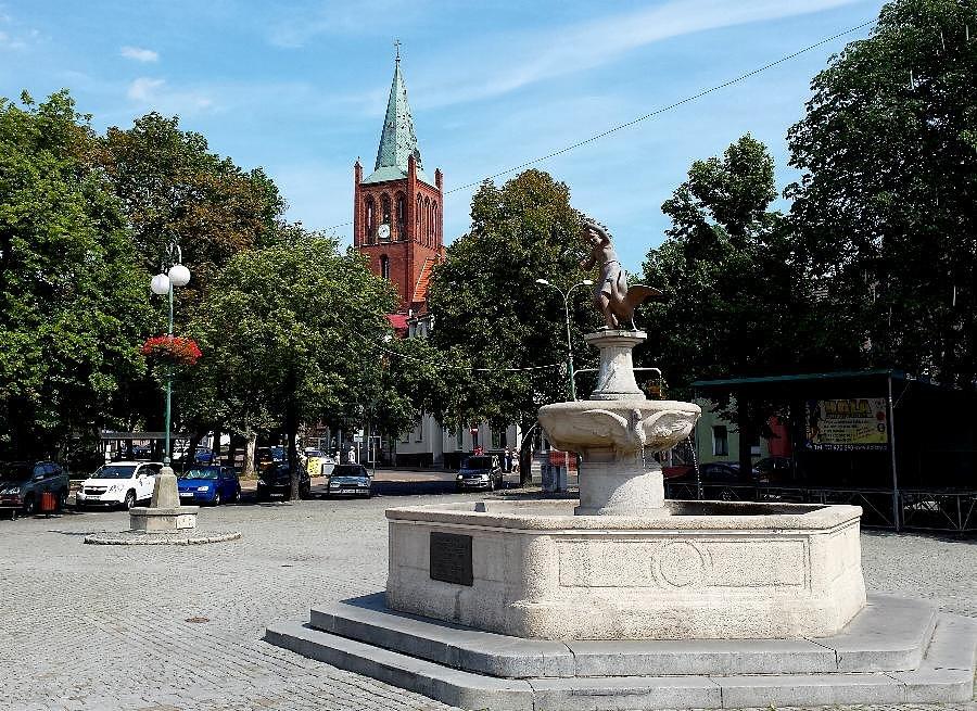 Pomnik gęsiarki na barlineckim rynku a w tle kościół