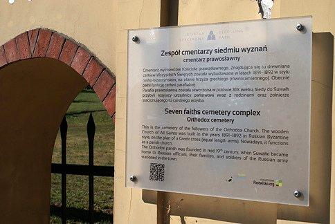 Tablica informacyjna przed bramą na cmentarz