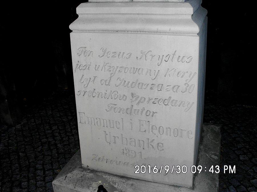 Napis na postumencie krzyża