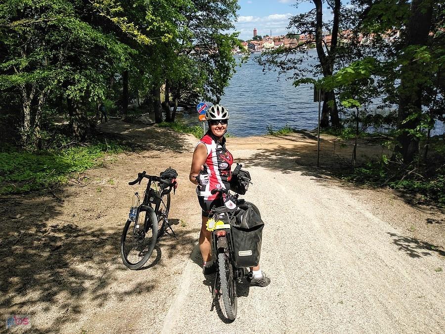 Rowerzysta z dwoma rowerami nad jeziorem