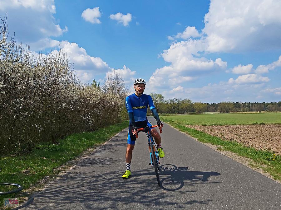 Kolarz na rowerze na wiejskiej drodze