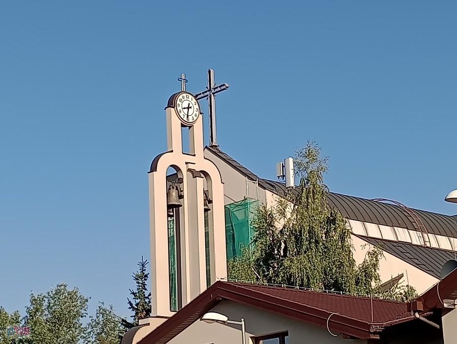 Wieża kościoła z krzyżem i zegarem