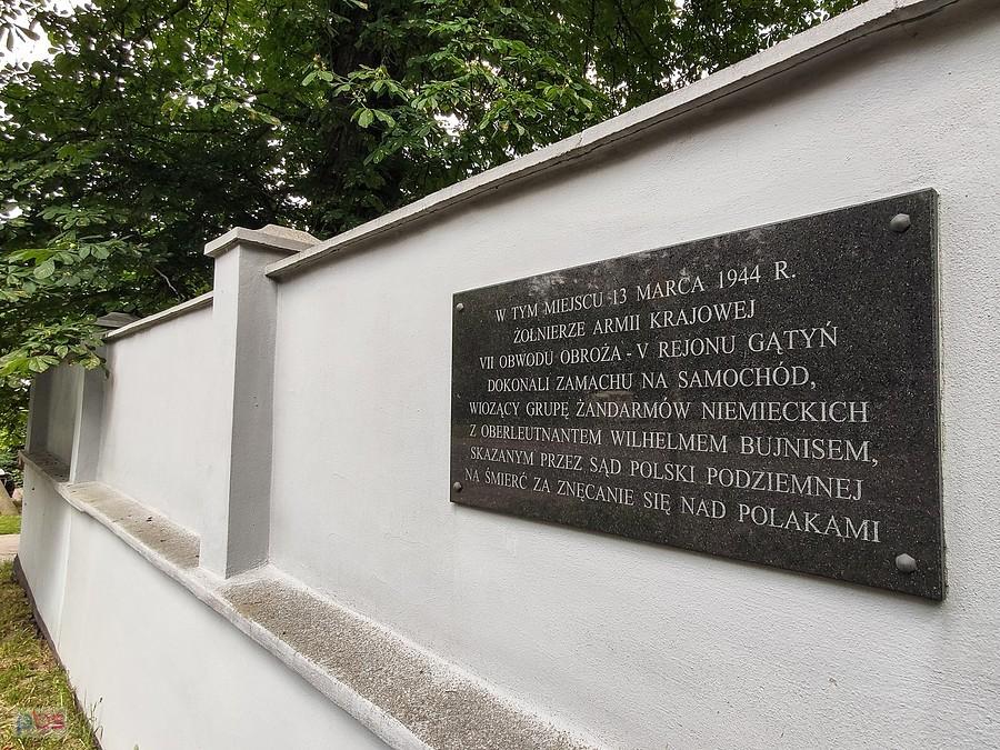 Tablica na murze cmentarza w Powsinie